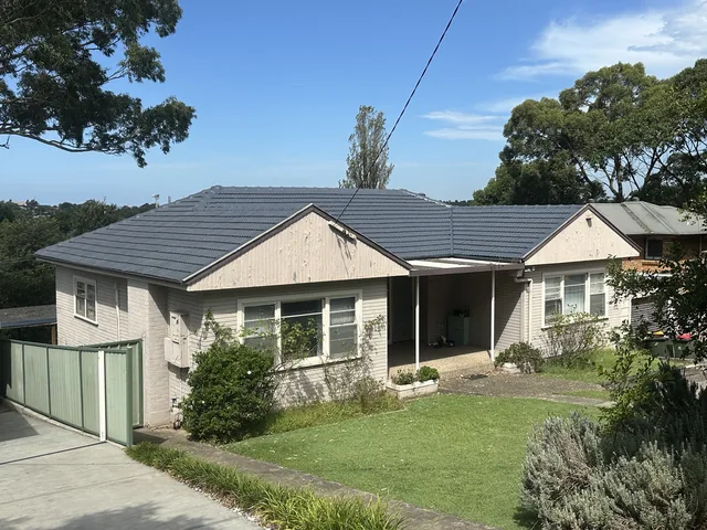 The same house with a dark charcoal tile roof, Basalt, after restoration.